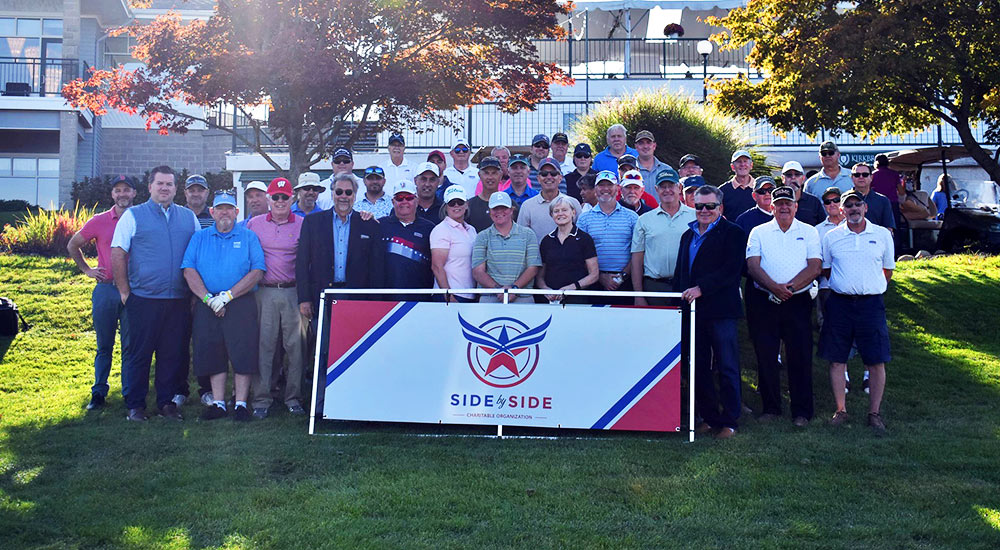 Golf event group shot with side by side logo banner